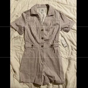 romper that has buttons, a collar and the stripes are baby pink and blue